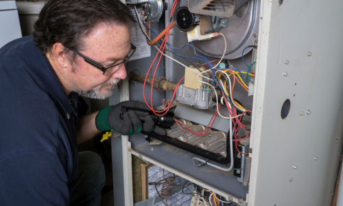 Technician Working On A Furnace
